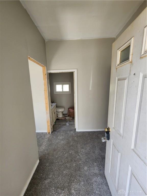 35 Utah Ct, Dayton, OH 45410 - hallway featuring dark carpet and baseboards