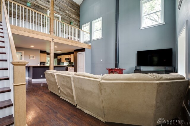 1803 Resor Rd, Fairfield, OH 45014 - living area with a towering ceiling, plenty of natural light, a wood stove, and dark wood-type flooring