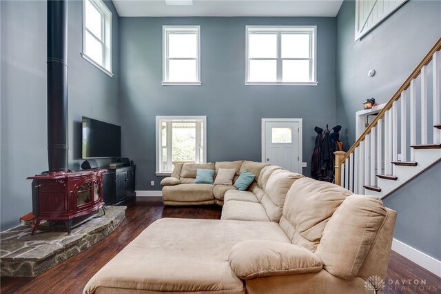 1803 Resor Rd, Fairfield, OH 45014 - living area with a high ceiling, a wood stove, stairs, wood finished floors, and baseboards