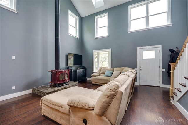1803 Resor Rd, Fairfield, OH 45014 - living room featuring stairway, high vaulted ceiling, a wood stove, wood finished floors, and baseboards