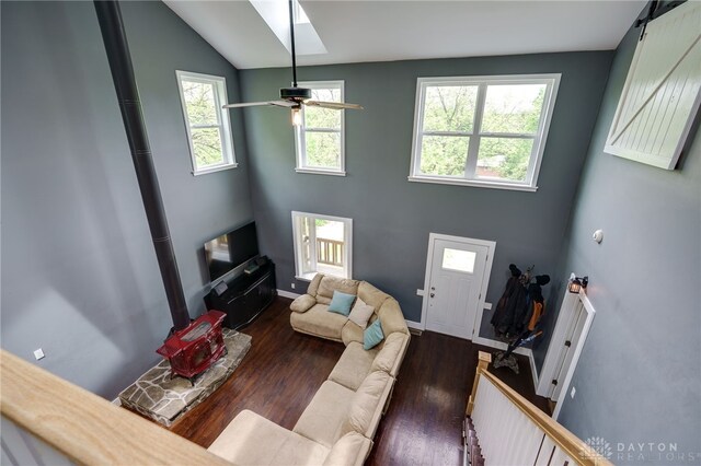 1803 Resor Rd, Fairfield, OH 45014 - living area with a wood stove, dark wood-style floors, healthy amount of natural light, a ceiling fan, and vaulted ceiling
