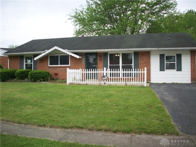 ranch-style home featuring brick siding and a shingled roof