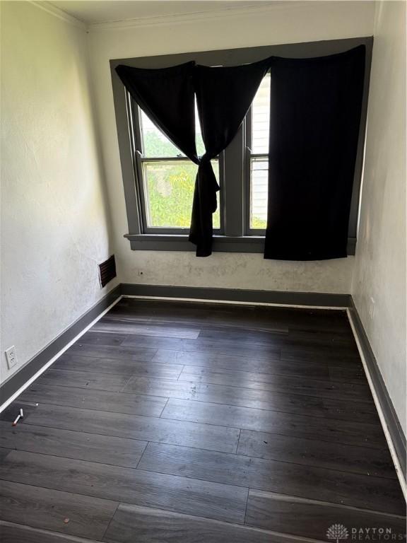 90 S Sperling Ave Unit 88, Dayton, OH 45403 - spare room featuring healthy amount of natural light, crown molding, dark wood finished floors, and baseboards