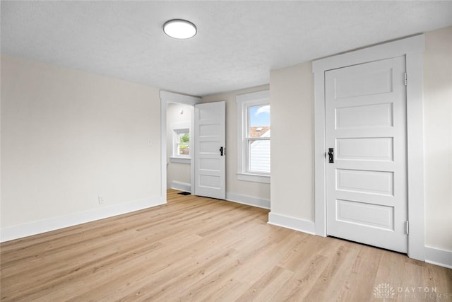 1235 W Jefferson St, Springfield, OH 45506 - unfurnished bedroom with light wood-type flooring, baseboards, and a textured ceiling