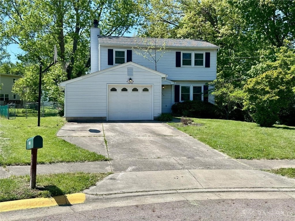 120 Acorn Cir, Oxford, OH 45056 - view of front of house featuring a chimney, concrete driveway, and an attached garage