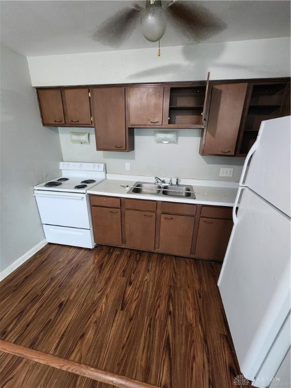 2620 N Gettysburg Ave, Dayton, OH 45406 - kitchen with white appliances, a sink, open shelves, and dark wood finished floors