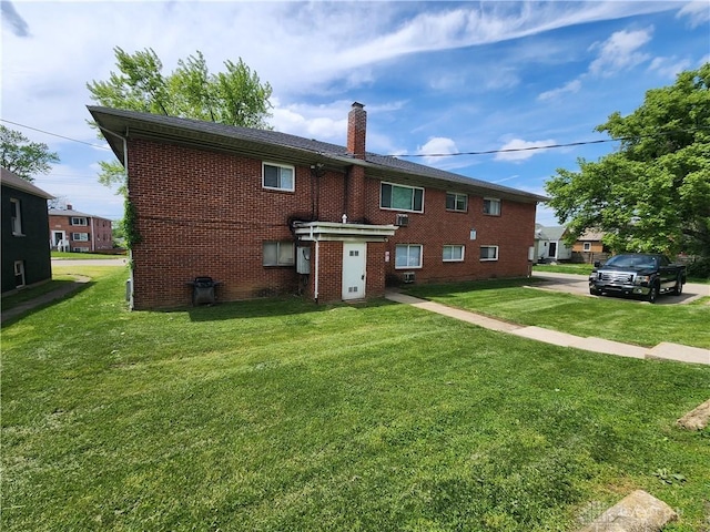 2620 N Gettysburg Ave, Dayton, OH 45406 - back of house with a chimney, brick siding, and a yard