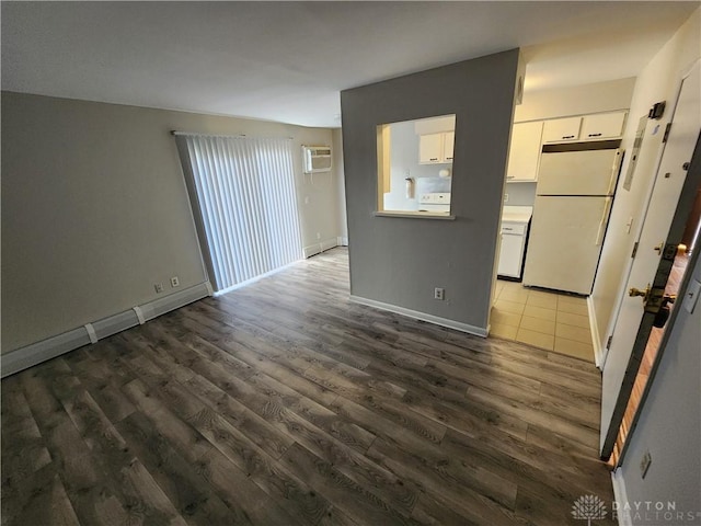 2620 N Gettysburg Ave, Dayton, OH 45406 - unfurnished living room with wood finished floors, a wall mounted AC, and baseboards