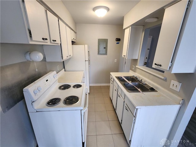 2620 N Gettysburg Ave, Dayton, OH 45406 - kitchen with white appliances, a sink, light countertops, light tile patterned floors, and white cabinets