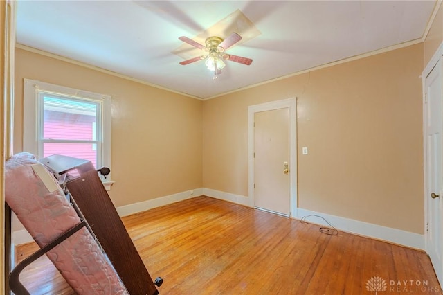 2108 Auburn Ave, Dayton, OH 45406 - empty room with crown molding, light wood-style floors, baseboards, and ceiling fan