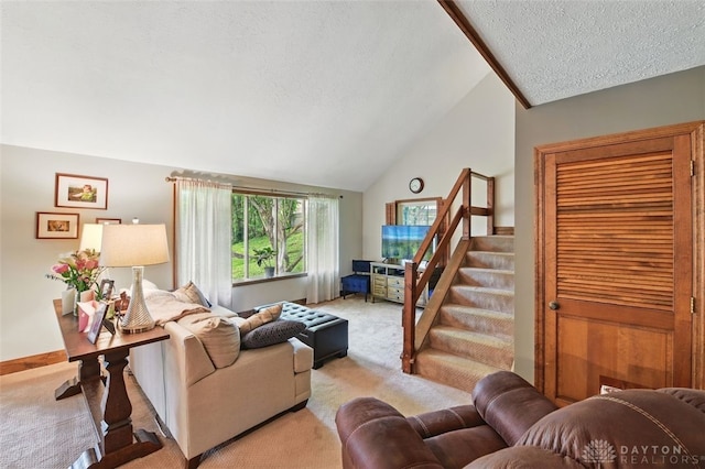 living room with carpet floors, a textured ceiling, vaulted ceiling, and stairs