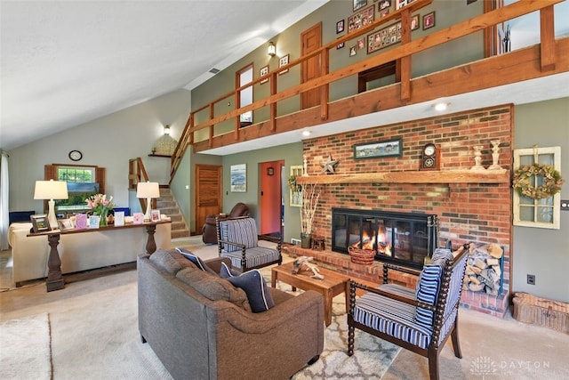 living area featuring carpet floors, stairway, a brick fireplace, and high vaulted ceiling