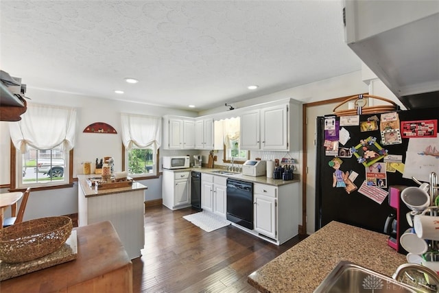 kitchen with black appliances, a sink, dark wood-style flooring, recessed lighting, and white cabinets