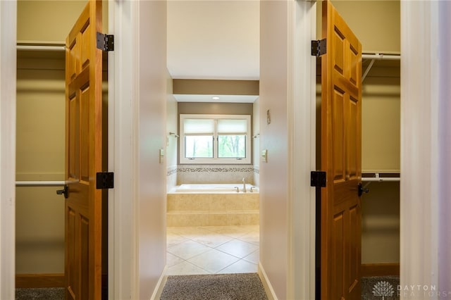 hallway with tile patterned floors