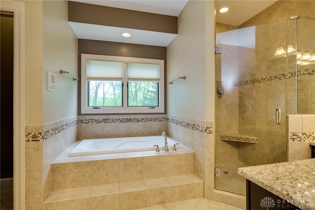 bathroom with a garden tub, a shower stall, vanity, tile patterned flooring, and recessed lighting