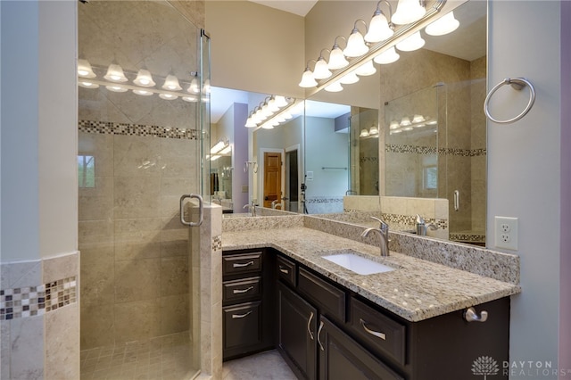 full bathroom featuring a shower stall and vanity