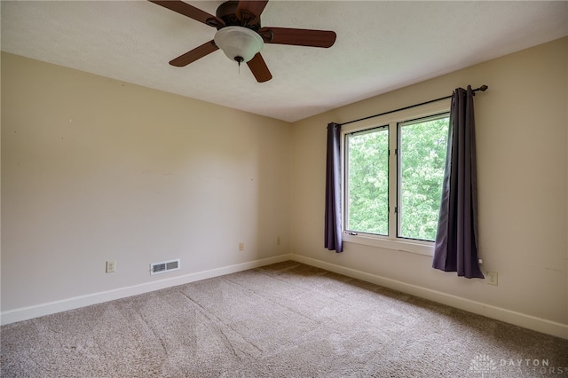 spare room featuring baseboards, carpet floors, and a ceiling fan