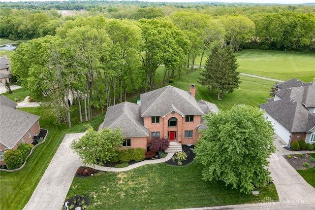 aerial view of property and surrounding area with a golf club