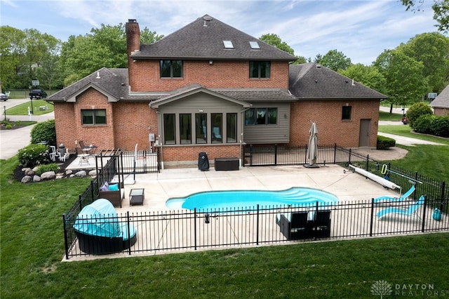 back of house featuring brick siding, a patio, a shingled roof, and a chimney