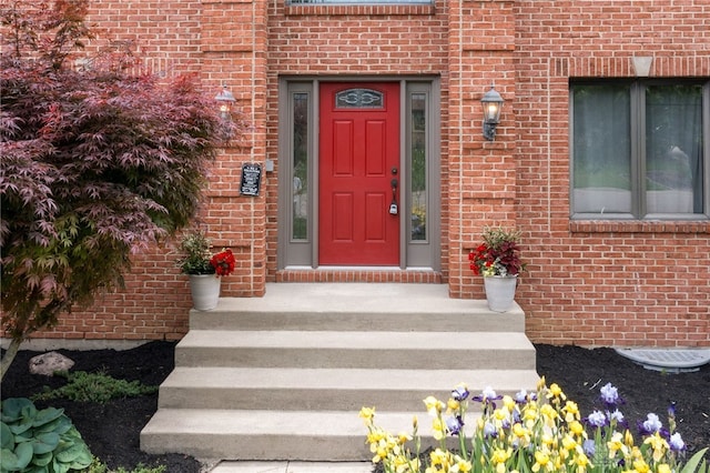doorway to property featuring brick siding