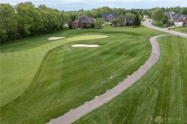 view of community featuring a putting green, view of golf course, and a yard
