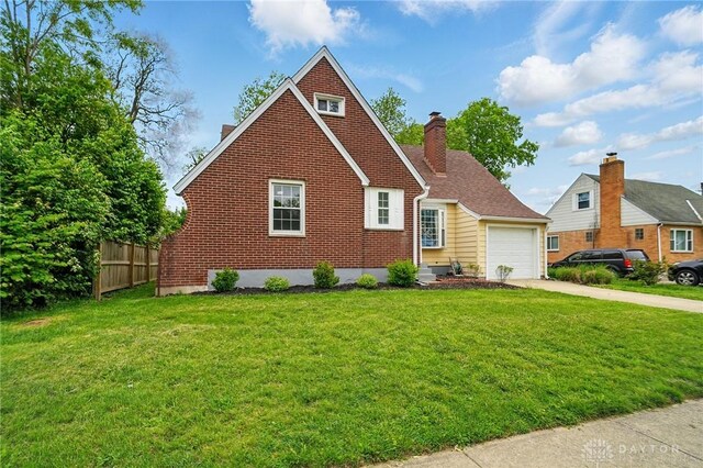 2917 California Ave, Dayton, OH 45419 - view of front facade with driveway, an attached garage, brick siding, and a chimney
