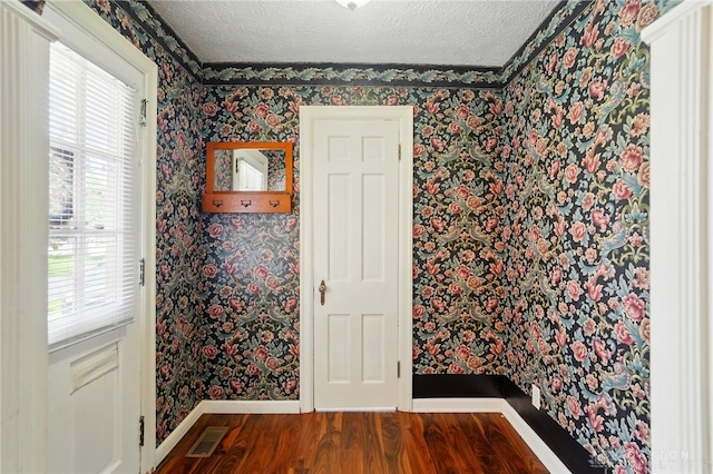2917 California Ave, Dayton, OH 45419 - unfurnished room featuring wallpapered walls, baseboards, wood finished floors, a textured ceiling, and healthy amount of natural light