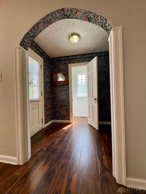 2917 California Ave, Dayton, OH 45419 - doorway featuring baseboards, dark wood finished floors, a textured ceiling, and wallpapered walls