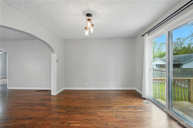 2917 California Ave, Dayton, OH 45419 - spare room with arched walkways, wood finished floors, a textured ceiling, and baseboards