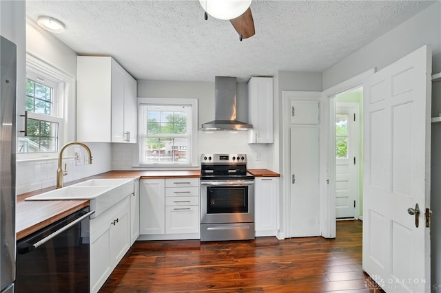 2917 California Ave, Dayton, OH 45419 - kitchen featuring wall chimney range hood, electric range, wood counters, dishwasher, and a textured ceiling