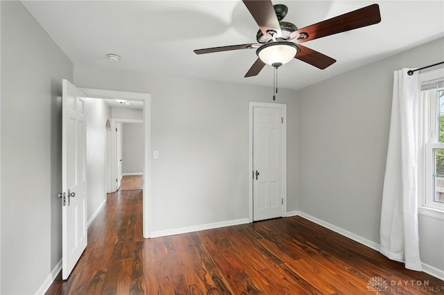 2917 California Ave, Dayton, OH 45419 - unfurnished bedroom featuring dark wood-style flooring, baseboards, and ceiling fan