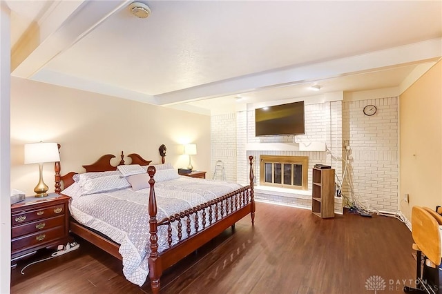 3033 E Linmuth Dr, Springfield, OH 45503 - bedroom with wood finished floors, a brick fireplace, and beam ceiling