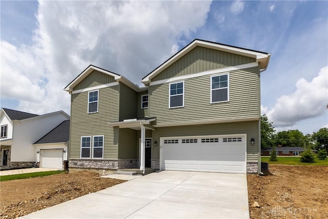 3402 Randall Dr, Cedarville Twp, OH 45314 - view of front of home featuring stone siding, driveway, a garage, and board and batten siding
