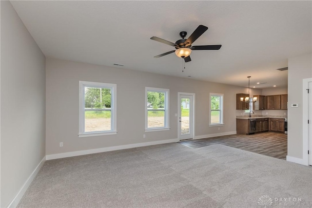 3402 Randall Dr, Cedarville Twp, OH 45314 - unfurnished living room with carpet floors, a chandelier, and a ceiling fan
