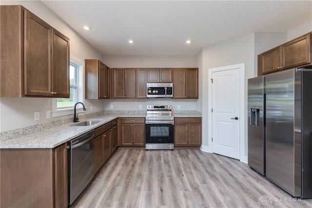 3402 Randall Dr, Cedarville Twp, OH 45314 - kitchen featuring appliances with stainless steel finishes, light wood-style flooring, recessed lighting, and light stone counters