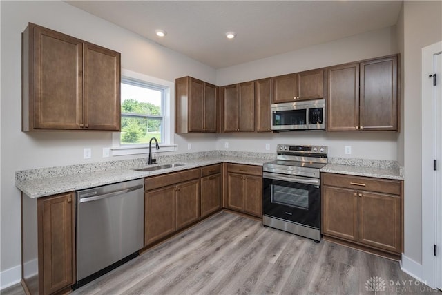 3402 Randall Dr, Cedarville Twp, OH 45314 - kitchen with stainless steel appliances, light wood finished floors, recessed lighting, and light stone countertops