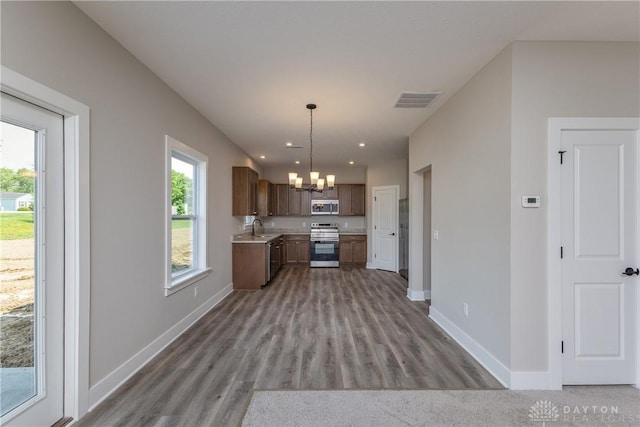 3402 Randall Dr, Cedarville Twp, OH 45314 - kitchen featuring appliances with stainless steel finishes, a chandelier, light countertops, wood finished floors, and recessed lighting