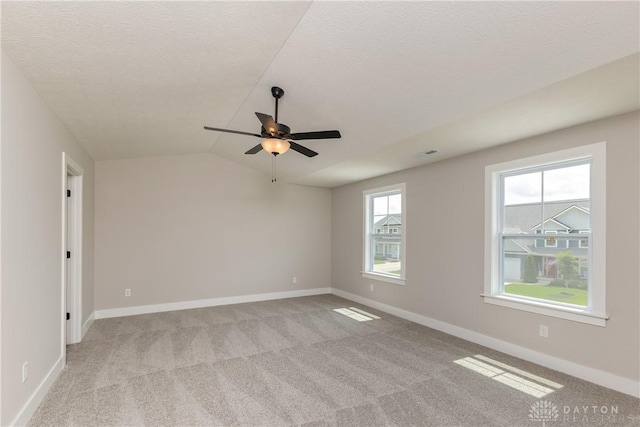 3402 Randall Dr, Cedarville Twp, OH 45314 - empty room featuring a ceiling fan, carpet, vaulted ceiling, and a textured ceiling