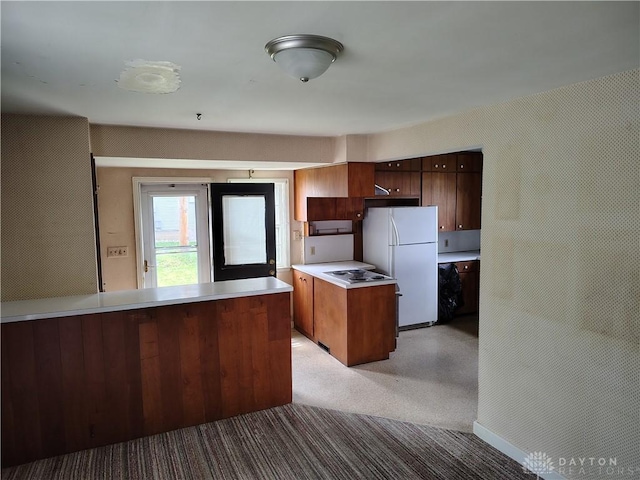465 W Staunton Rd, Troy, OH 45373 - kitchen featuring freestanding refrigerator, light colored carpet, light countertops, modern cabinets, and a peninsula