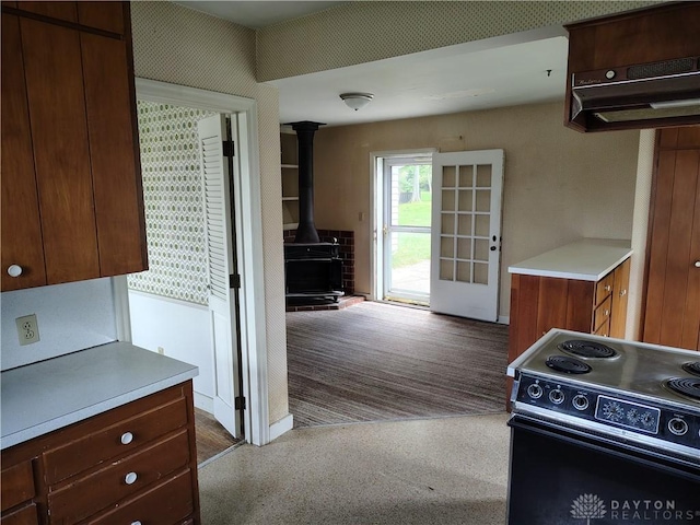 465 W Staunton Rd, Troy, OH 45373 - kitchen featuring black electric range, a wood stove, light countertops, and under cabinet range hood