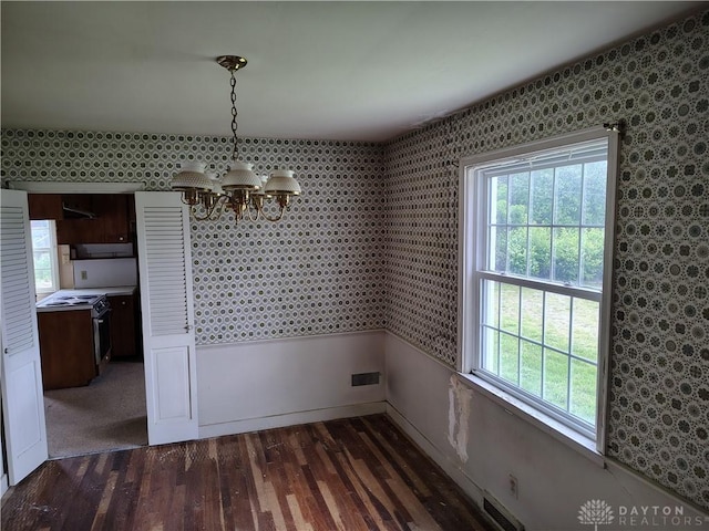 465 W Staunton Rd, Troy, OH 45373 - unfurnished dining area with a chandelier and wood finished floors