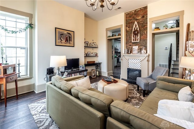 320 N Mechanic St, Lebanon, OH 45036 - living area featuring a chandelier, healthy amount of natural light, a tiled fireplace, and dark wood finished floors