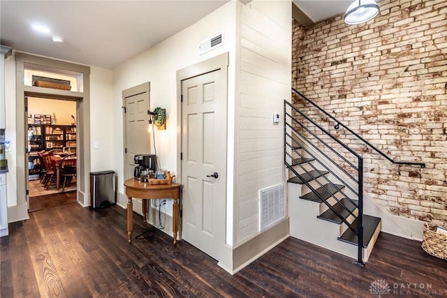 320 N Mechanic St, Lebanon, OH 45036 - entryway featuring dark wood-style floors, brick wall, stairs, and baseboards