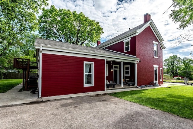 320 N Mechanic St, Lebanon, OH 45036 - view of front of property featuring a chimney, a front yard, stairs, and a wooden deck