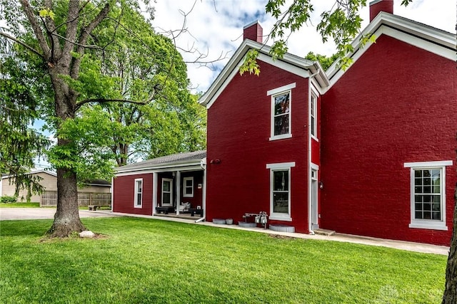 320 N Mechanic St, Lebanon, OH 45036 - rear view of house with a chimney, a lawn, and brick siding