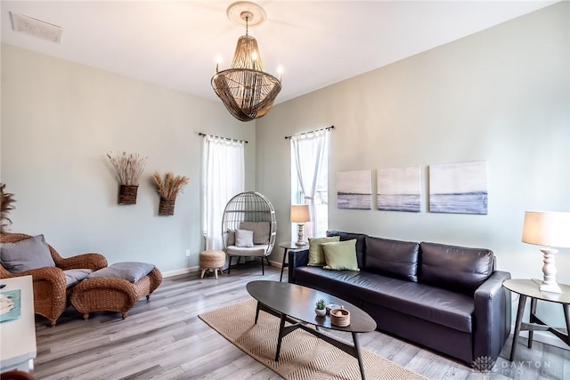 320 N Mechanic St, Lebanon, OH 45036 - living room featuring a chandelier, light wood-style floors, and baseboards