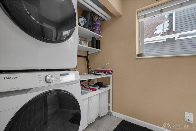 1395 Chickasaw Dr, London, OH 43140 - washroom with stacked washer and clothes dryer, baseboards, and light marble finish floors