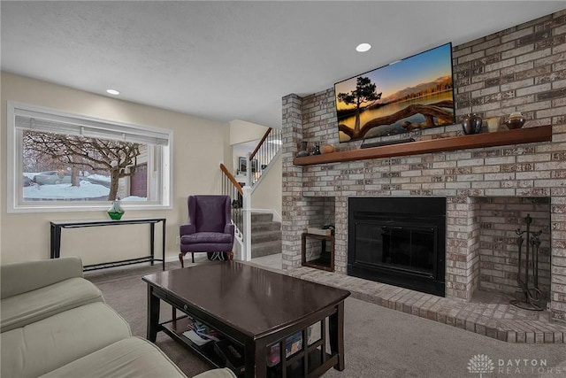 1395 Chickasaw Dr, London, OH 43140 - living room featuring carpet, a brick fireplace, stairway, and recessed lighting