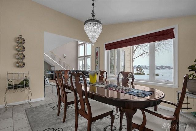 1395 Chickasaw Dr, London, OH 43140 - dining space with light tile patterned flooring, a chandelier, and baseboards