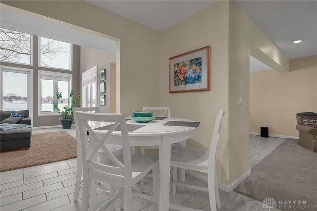 1395 Chickasaw Dr, London, OH 43140 - dining room with light tile patterned flooring, baseboards, and light colored carpet